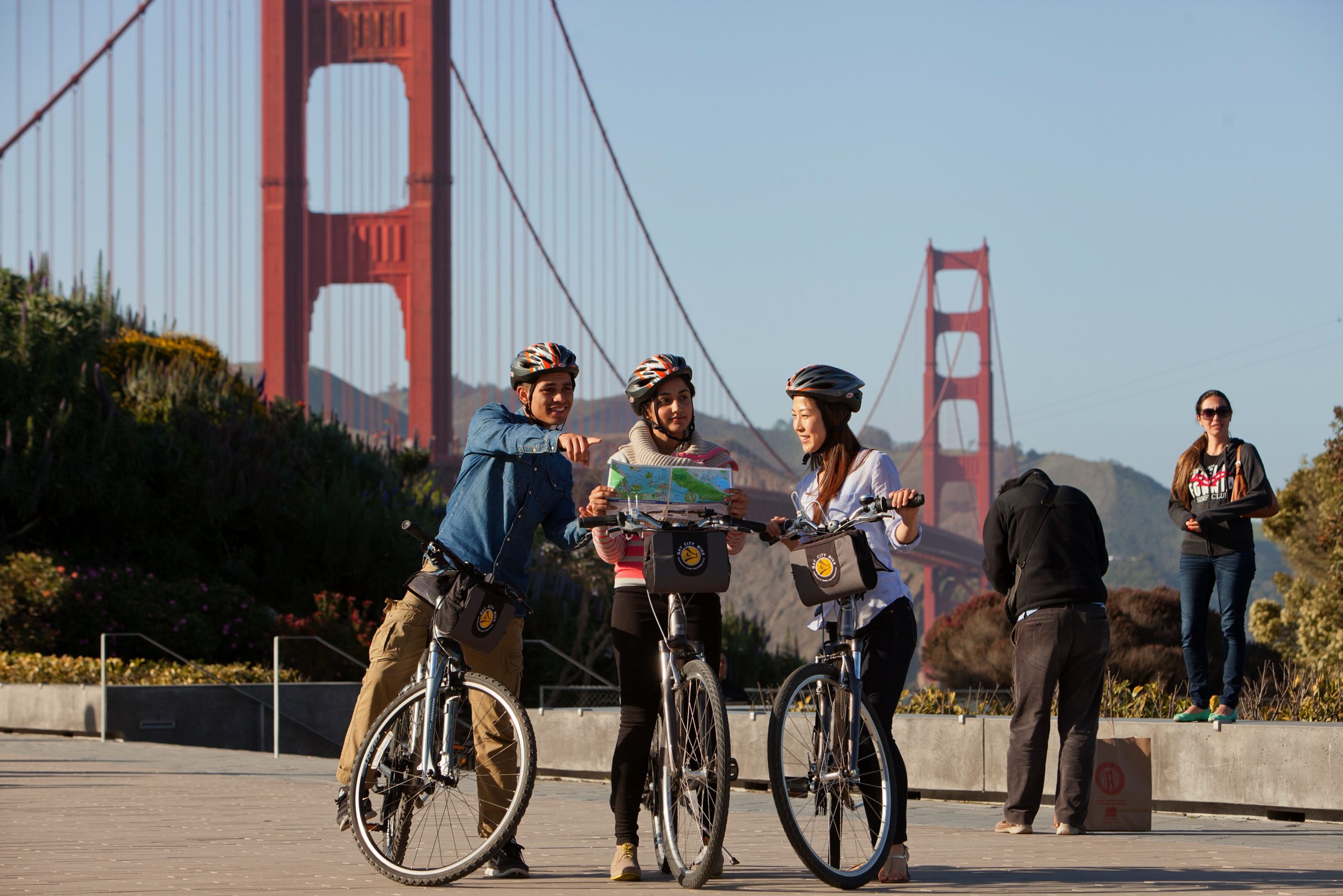 looking at map in front of golden gate bridge san francisco