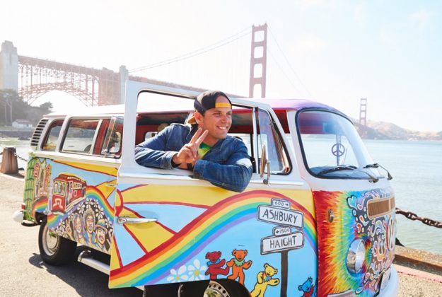 man posing with san francisco love tours hippie van