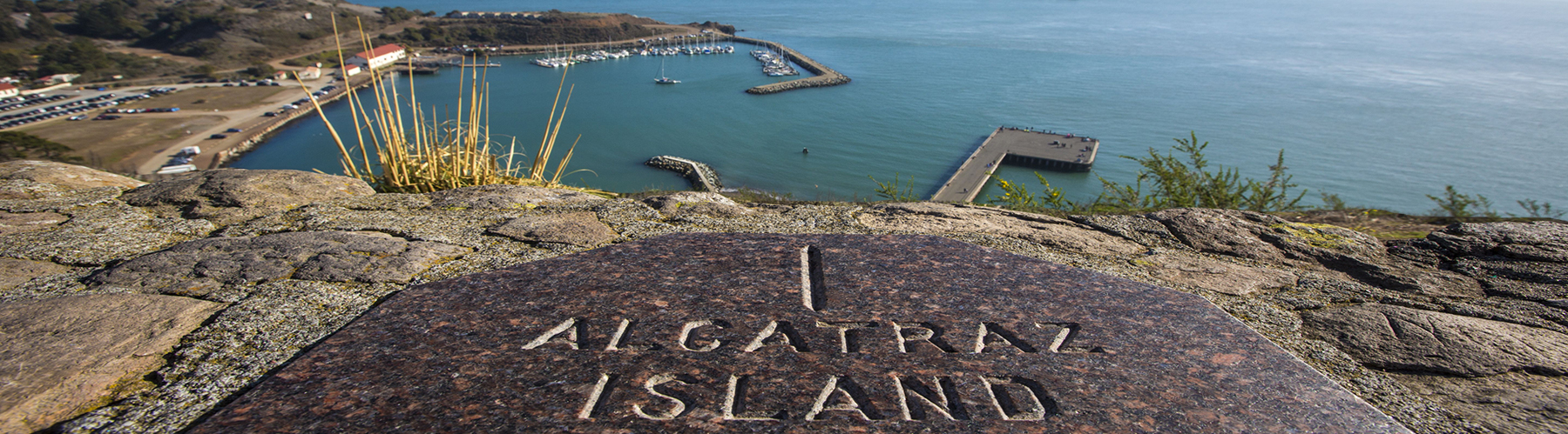 a stone indicating alcatraz island overlooking the san francisco bay while on on an alcatraz bike tour