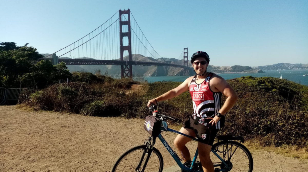 a man with his bike in presidio park overlooking the golden gate bridge