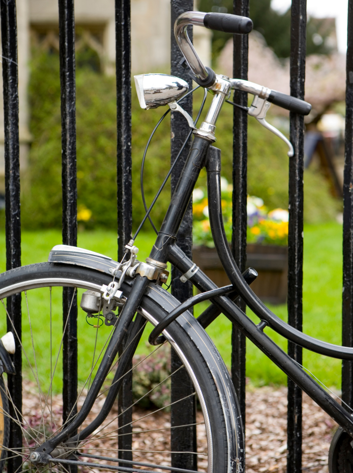 bike that is locked up to an iron fence