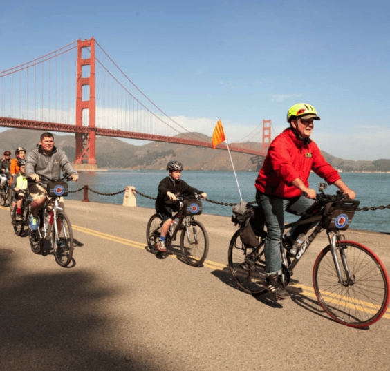 a group riding their rented bikes near golden gate bridge