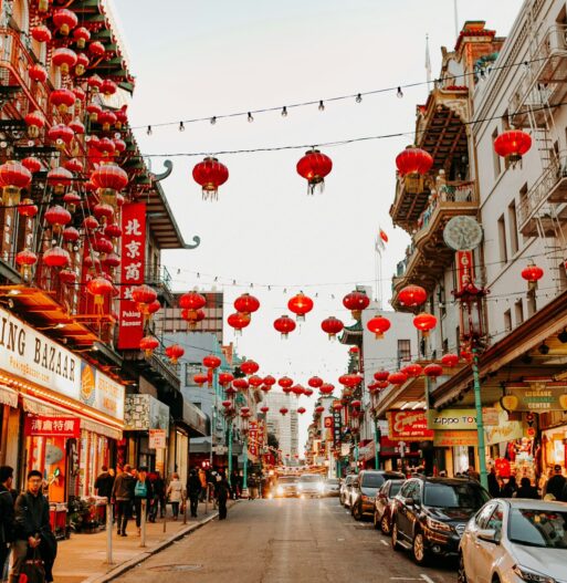 View of Chinatown in San Francisco, with red lamps and crowds ambling through the area