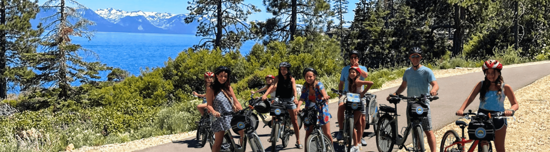 a family smiles while sitting on their bike rentals in lake tahoe during a long weekend trip