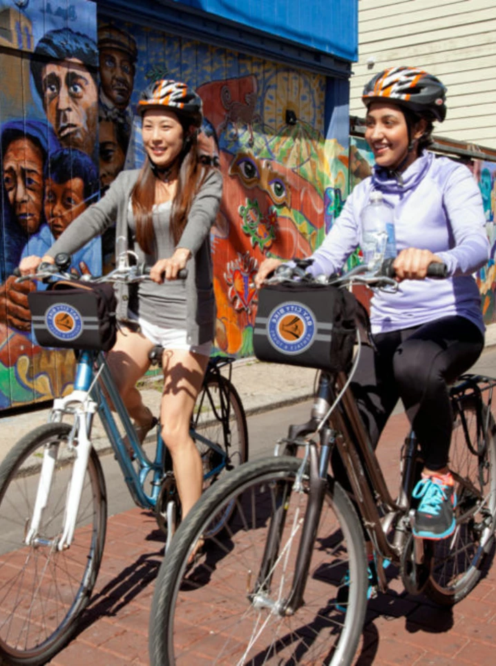bike friendly neighborhoods in san francisco two women riding bikes in a neighborhood in san francisco with a mural in the background